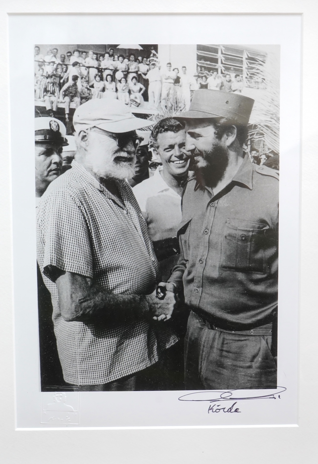 Alberto Korda (1928-2001), ‘Fidel Castro and Ernest Hemingway shaking hands’, stamped, signed in ink to the margin, with ADK blind stamp, gelatin silver print, 28 x 19cm